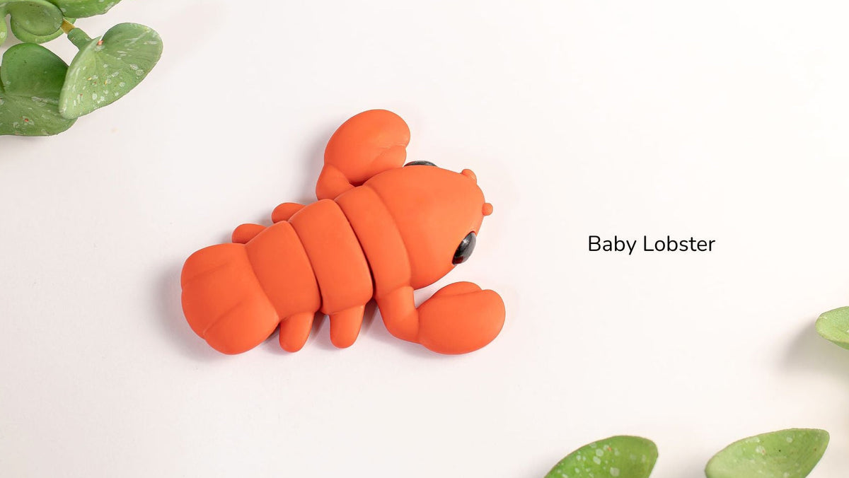 Baby Lobster beside green leaves