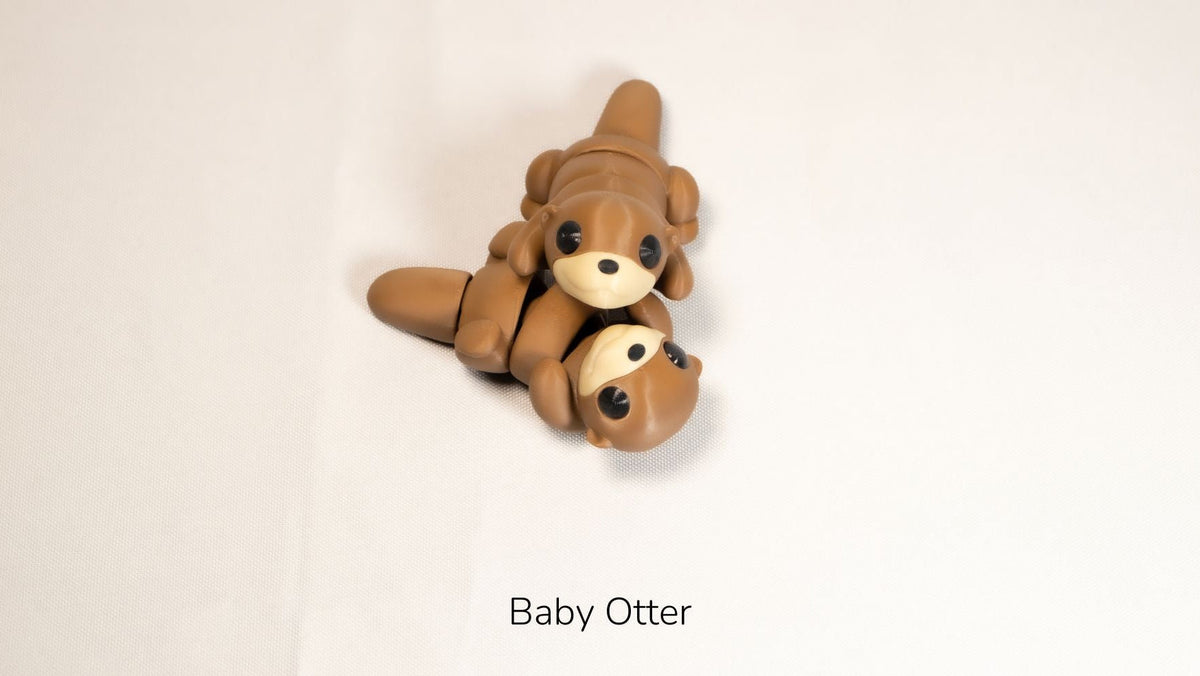 Brown Baby Otter fidget toy lying on its back
