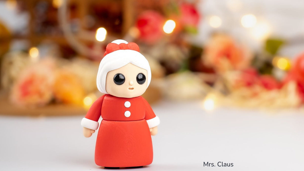 Mrs Claus figure with big eyes and a red dress