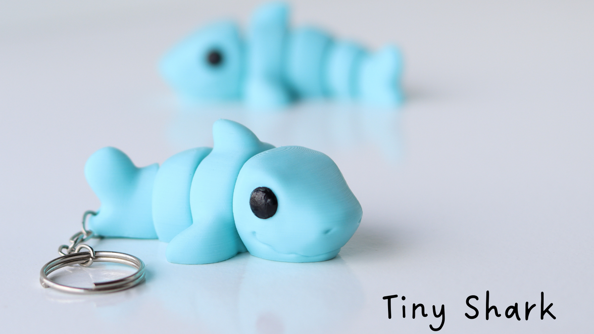 Blue shark keychain on a white background with 'Tiny Shark' text.