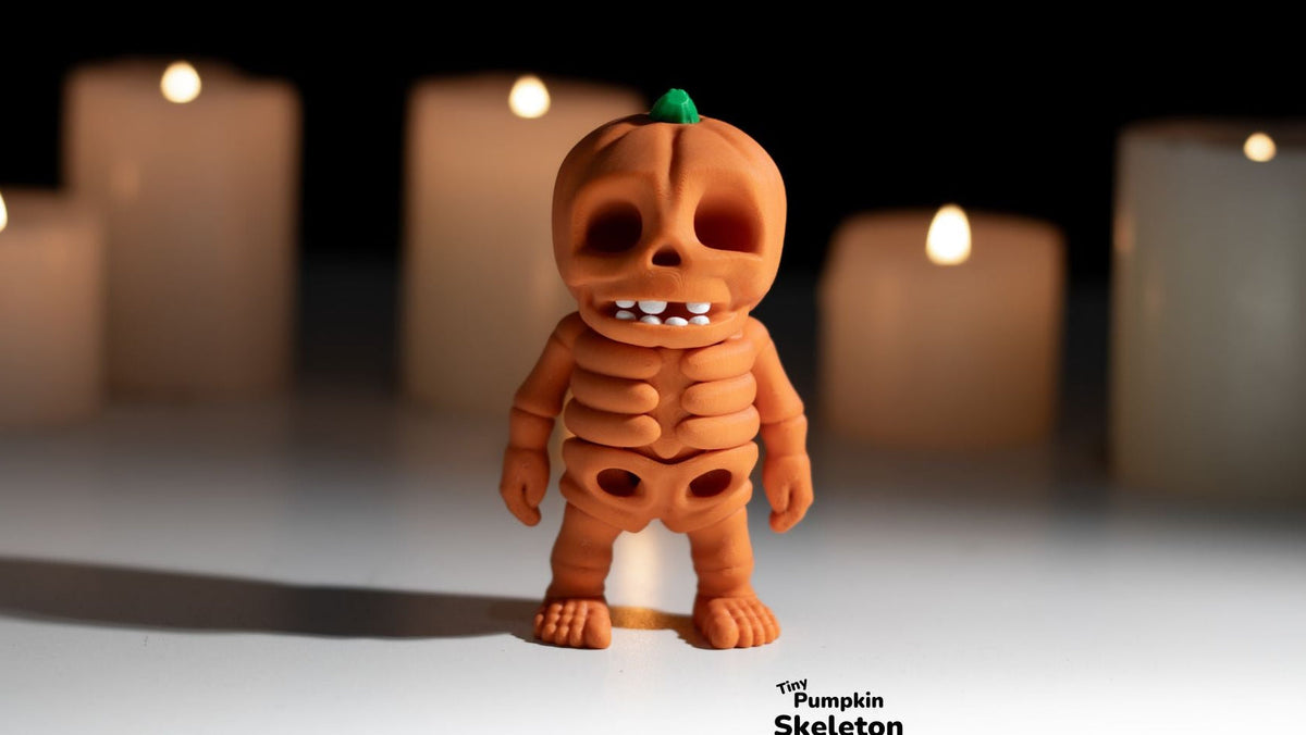 Orange Tiny Pumpkin Skeleton figure with candles behind