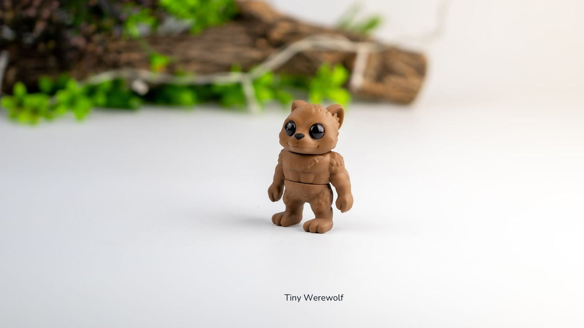 Small brown werewolf figurine on a white surface with greenery in the background