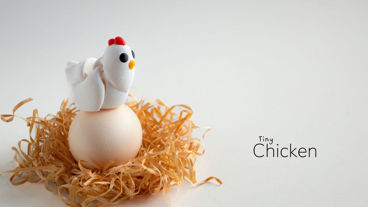 Small chicken figurine on a nest of straw with a white background