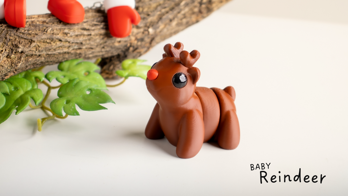 Brown Baby Reindeer with a red nose beside a branch