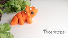 Orange Baby Triceratops with leaves behind