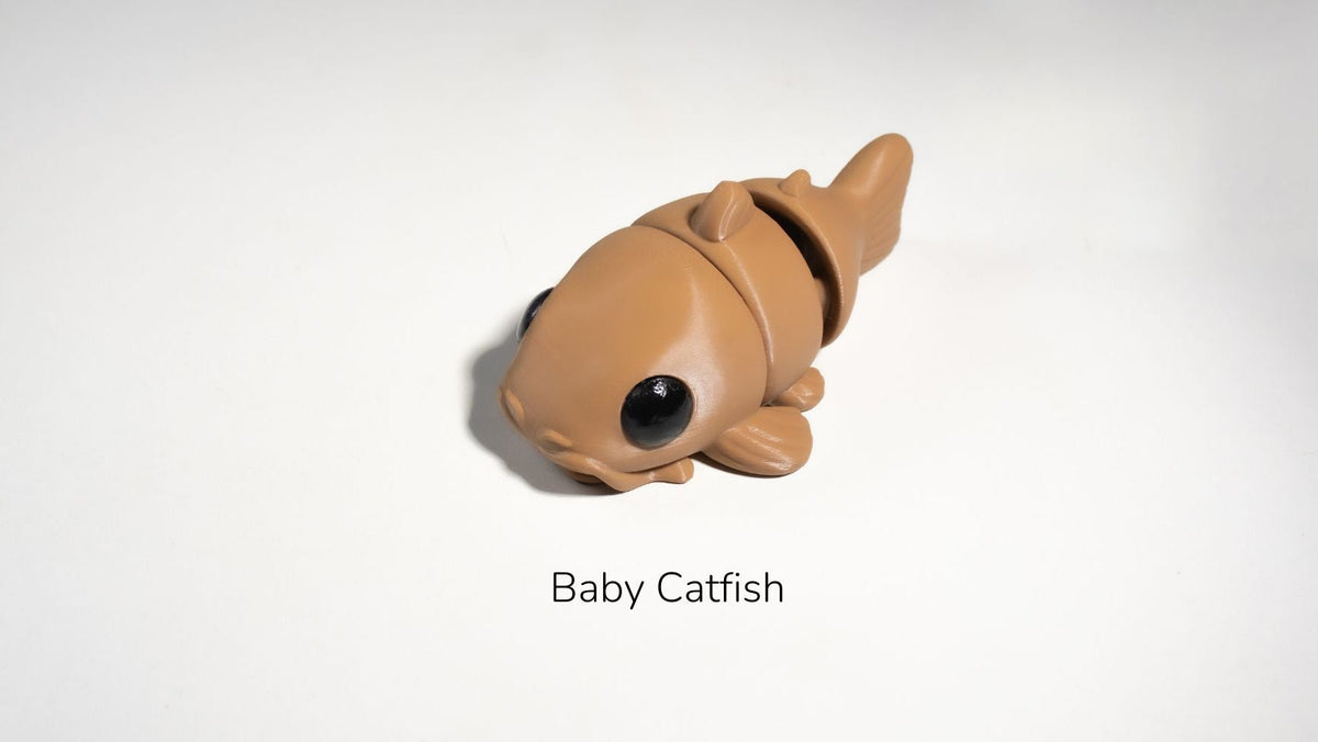 Toy catfish on a white background with 'Baby Catfish' text.