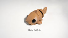 Toy catfish on a white background with 'Baby Catfish' text.