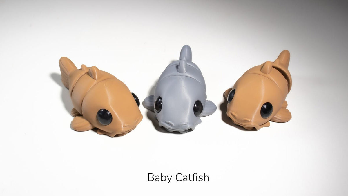 Two Baby Catfish fidget toys in brown and grey