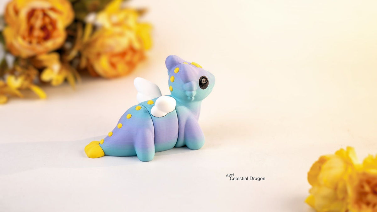 Blue dragon figurine with yellow accents on a light background with yellow flowers