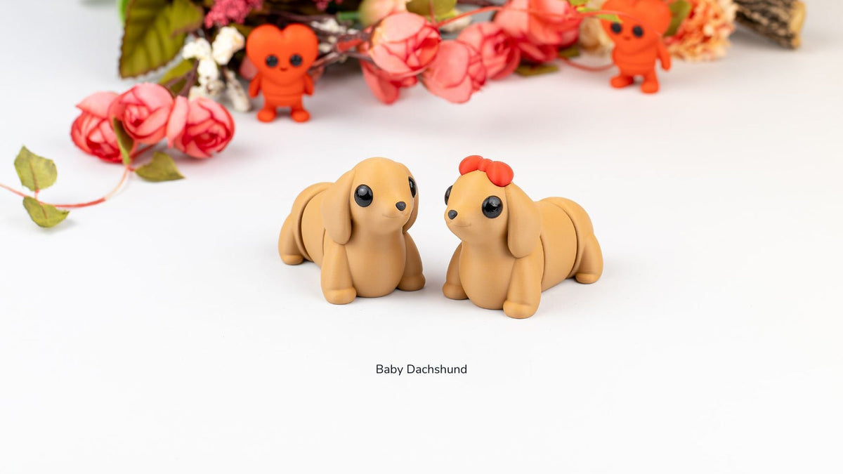 Two Baby Dachshunds with roses and flowers behind