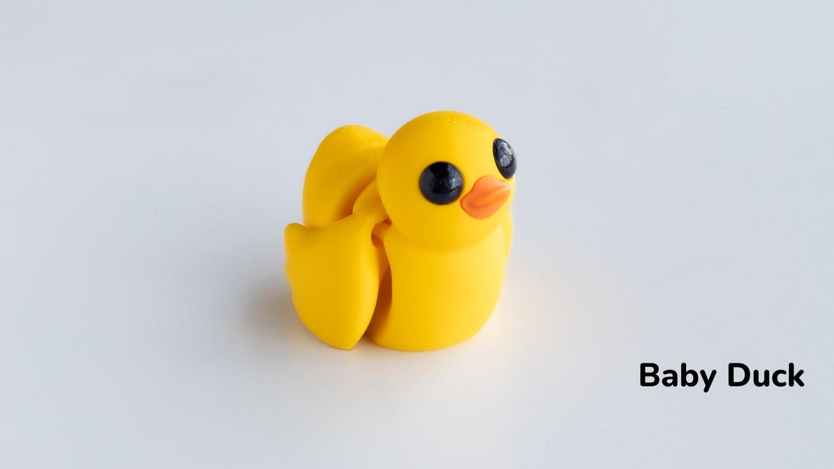 Yellow rubber duck toy on a light gray background with 'Baby Duck' text.