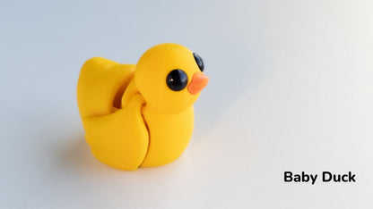 Yellow baby duck made of clay on a white background