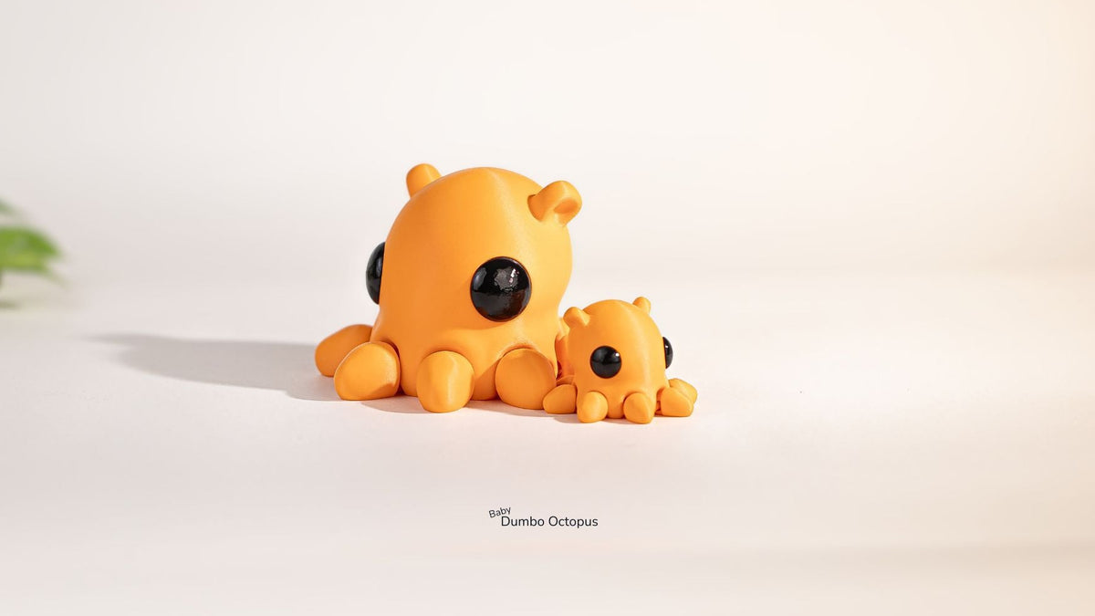 Two orange octopus toys on a light beige background