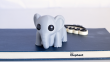 3D-printed elephant model on a blue surface with 'Replicatr' branding.