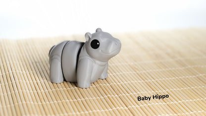 Gray hippo-shaped object on a bamboo mat with 'Baby Hippo' text