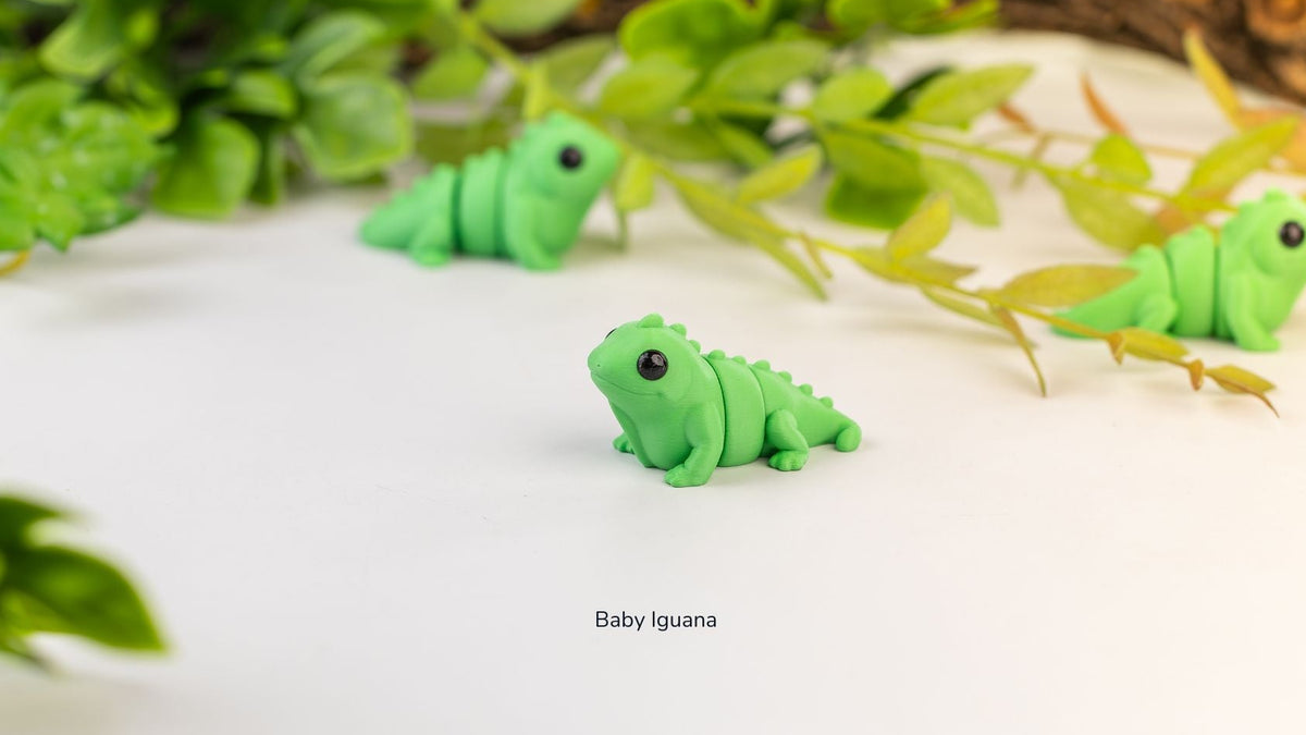 Green Baby Iguanas resting in front of plants