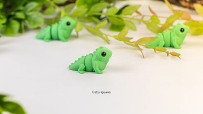 Two green Baby Iguana fidget toys side by side