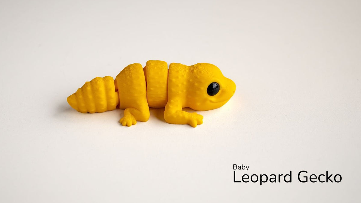 Yellow toy leopard gecko on a white background with 'Baby Leopard Gecko' text.