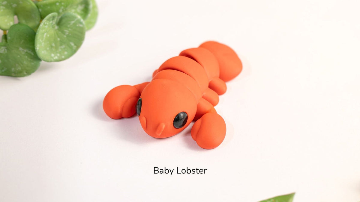 Orange Baby Lobster fidget toy with leaves