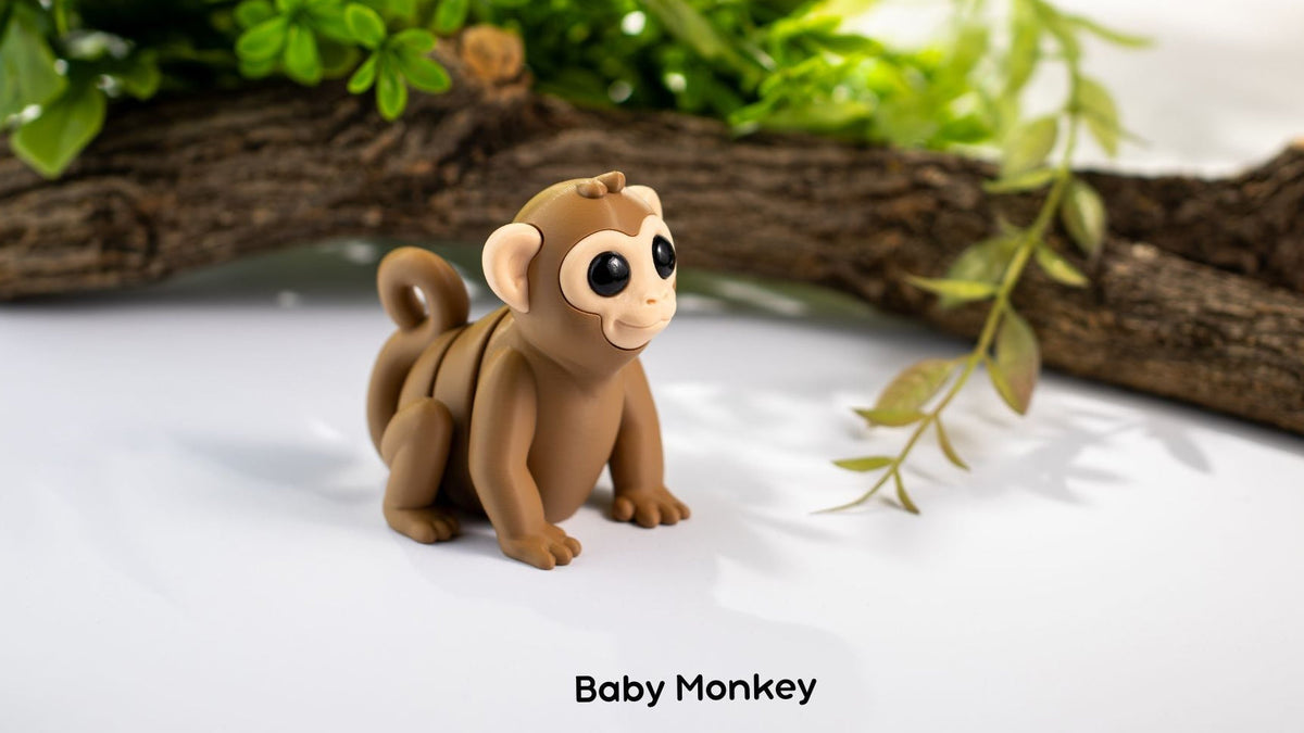 Brown Baby Monkey fidget toy with a branch and leaves behind
