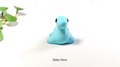 Light blue Baby Ness fidget toy, a small loch monster