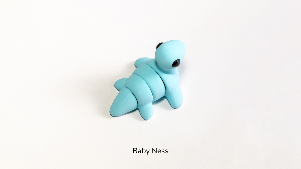 Blue Baby Ness with long neck on a white surface