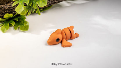 Orange Baby Pterodactyl fidget toy lying flat