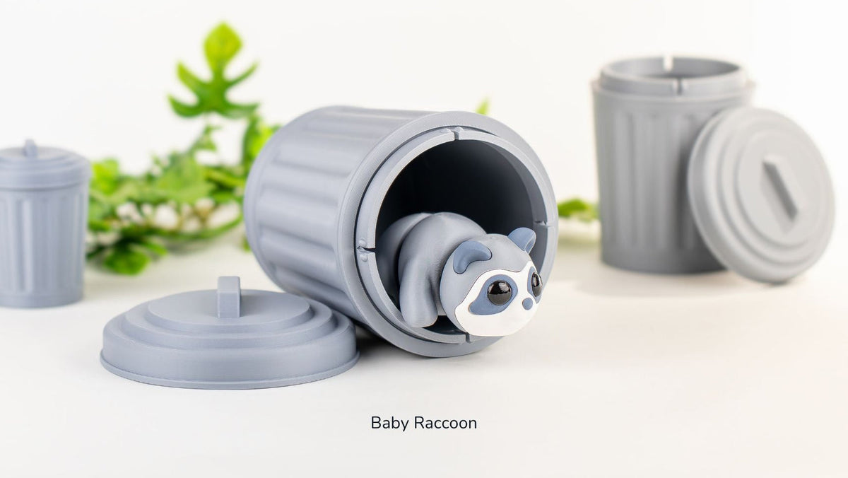 Baby Raccoon with two Trash Cans