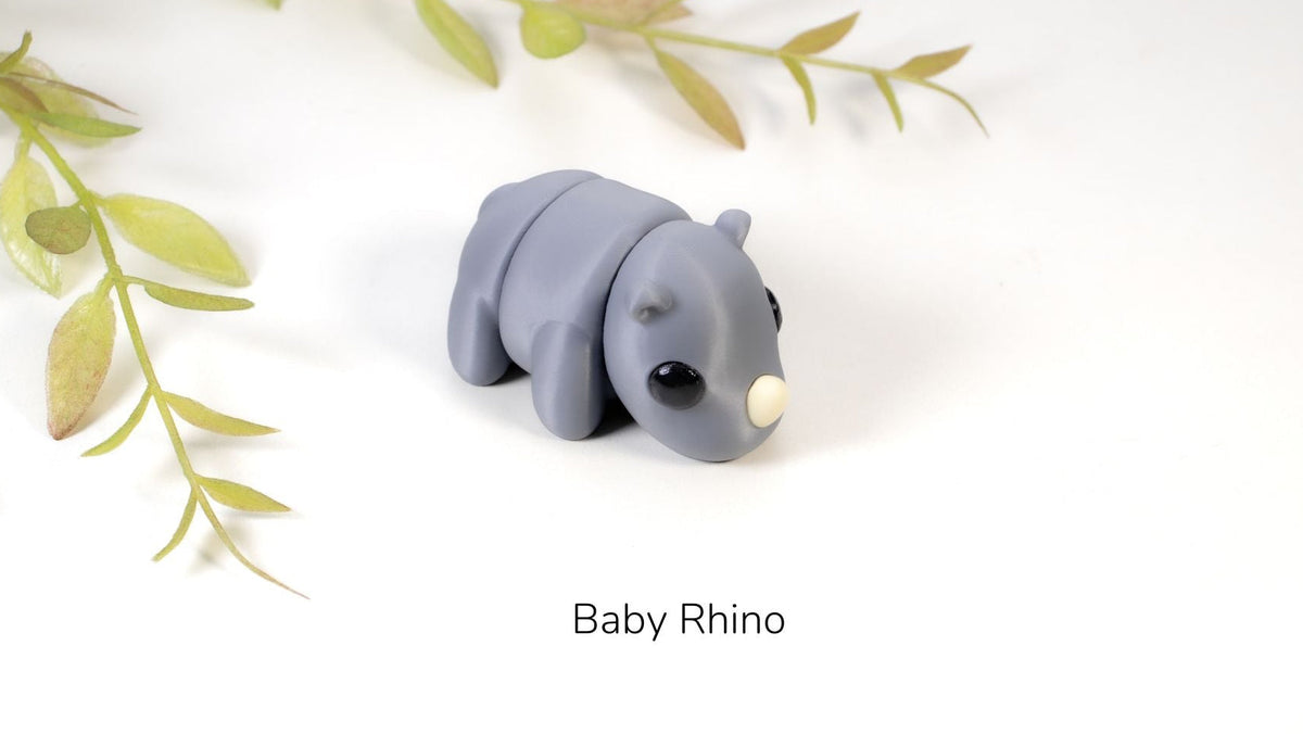 Grey Baby Rhino fidget toy with leaves behind