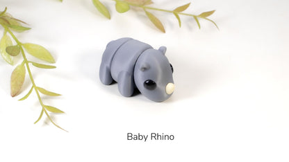 Grey Baby Rhino fidget toy with leaves behind
