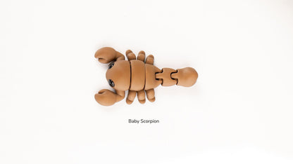 Articualted toy resembling a baby scorpion on a white background