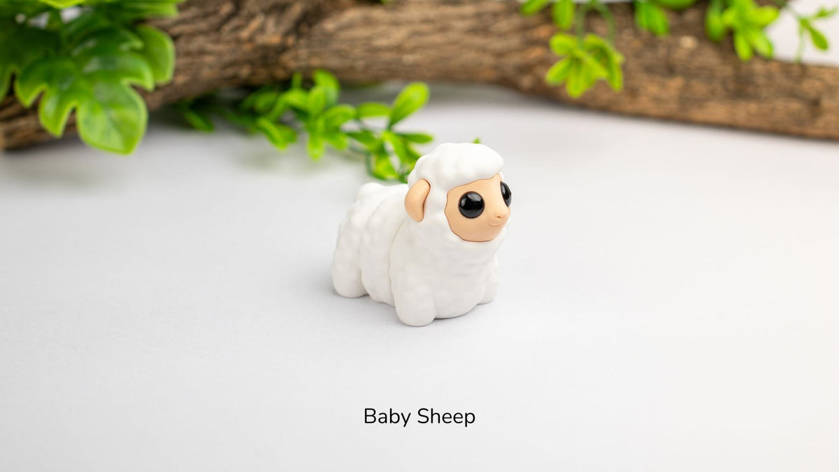 White Baby Sheep fidget toy with greenery behind