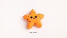 Orange baby starfish toy on a white background