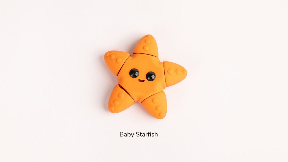 Orange baby starfish toy on a white background