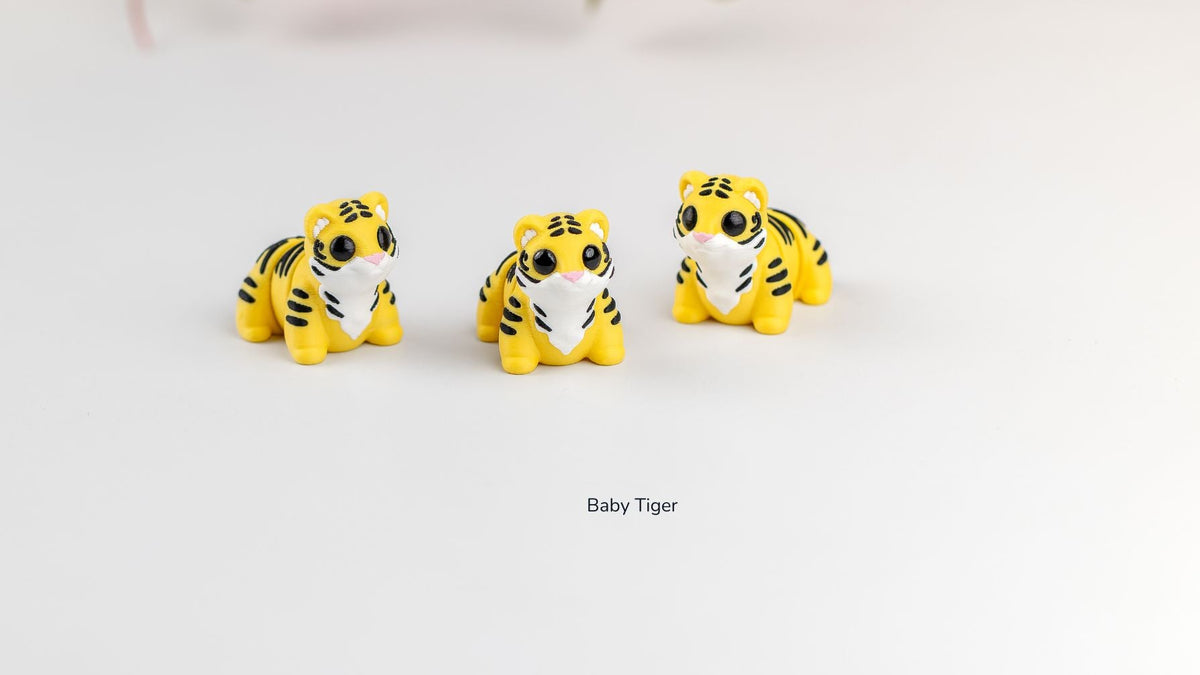 Three yellow Baby Tigers with black stripes