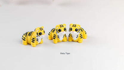 Group of Baby Tiger fidget toys on a white surface