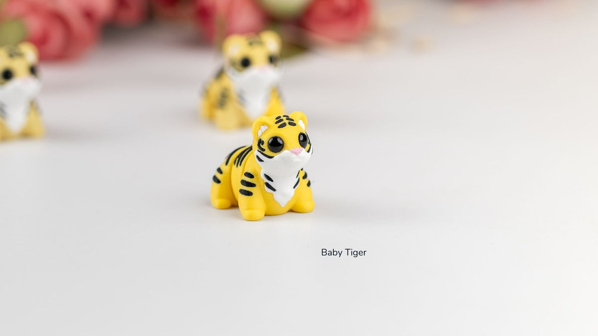 Baby Tigers in front of pink flowers