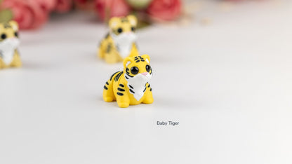 Baby Tigers in front of pink flowers