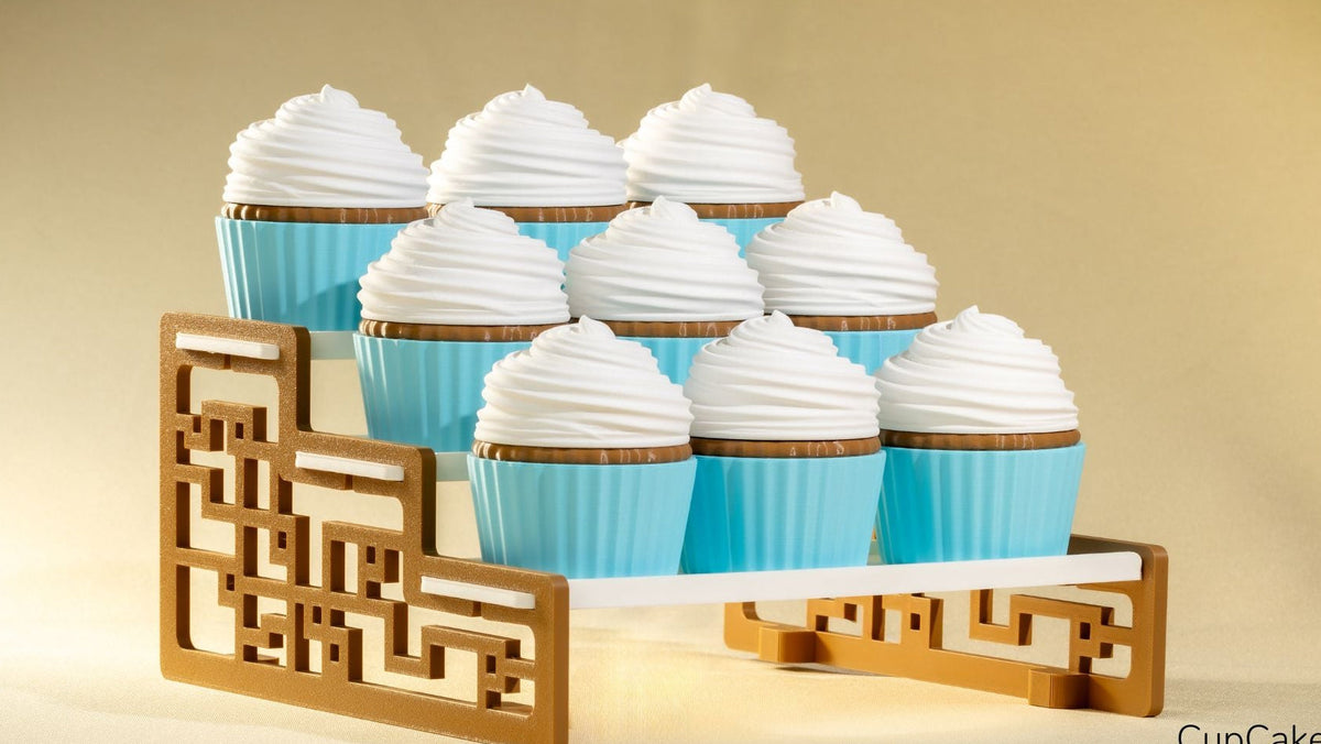 Cupcakes with white frosting and blue wrappers on a decorative wooden stand against a beige background.