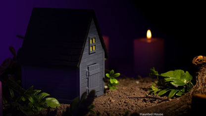 Grey Haunted House with glowing windows and candles on a dark purple background