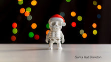 White skeleton figurine wearing a Santa hat with colorful lights in the background