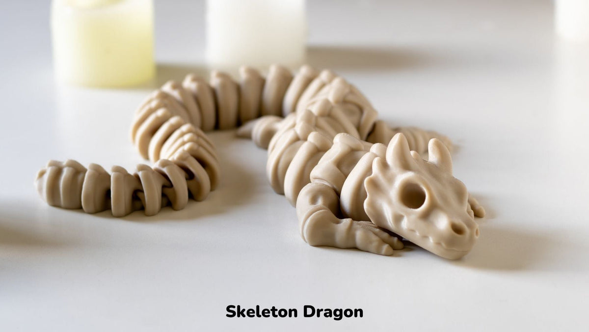 Cream Skeleton Noodle Dragon curled on a white surface