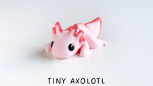 Pink toy axolotl on a white background with 'TINY AXOLOTL' text.