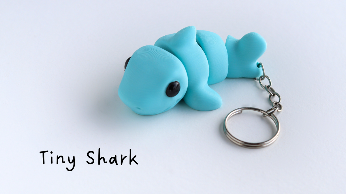 Blue shark keychain on a white background with 'Tiny Shark' text.