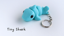 Blue shark keychain on a white background with 'Tiny Shark' text.