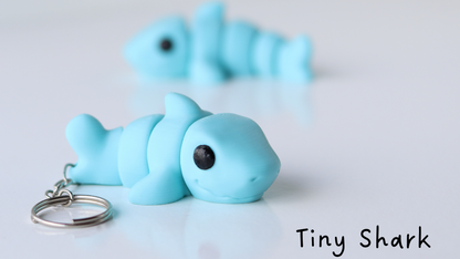 Blue shark keychain on a white background with 'Tiny Shark' text.