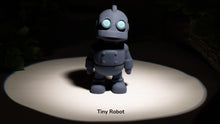 Small robot toy on a dark background with 'Tiny Robot' text