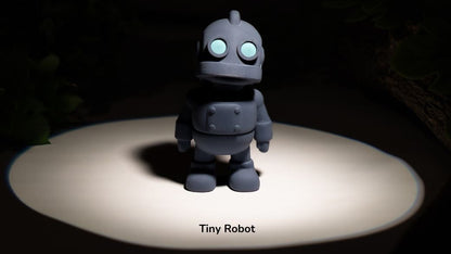 Small robot toy on a dark background with 'Tiny Robot' text