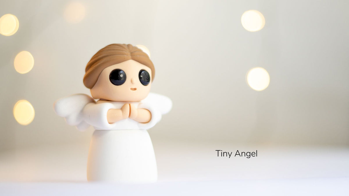 Small angel figurine with a blurred light background