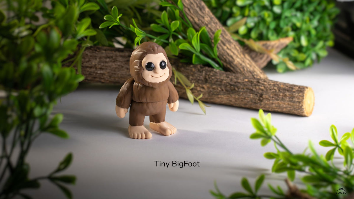 Brown Tiny Bigfoot figure in front of a log and leaves